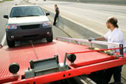 Towing truck taking car